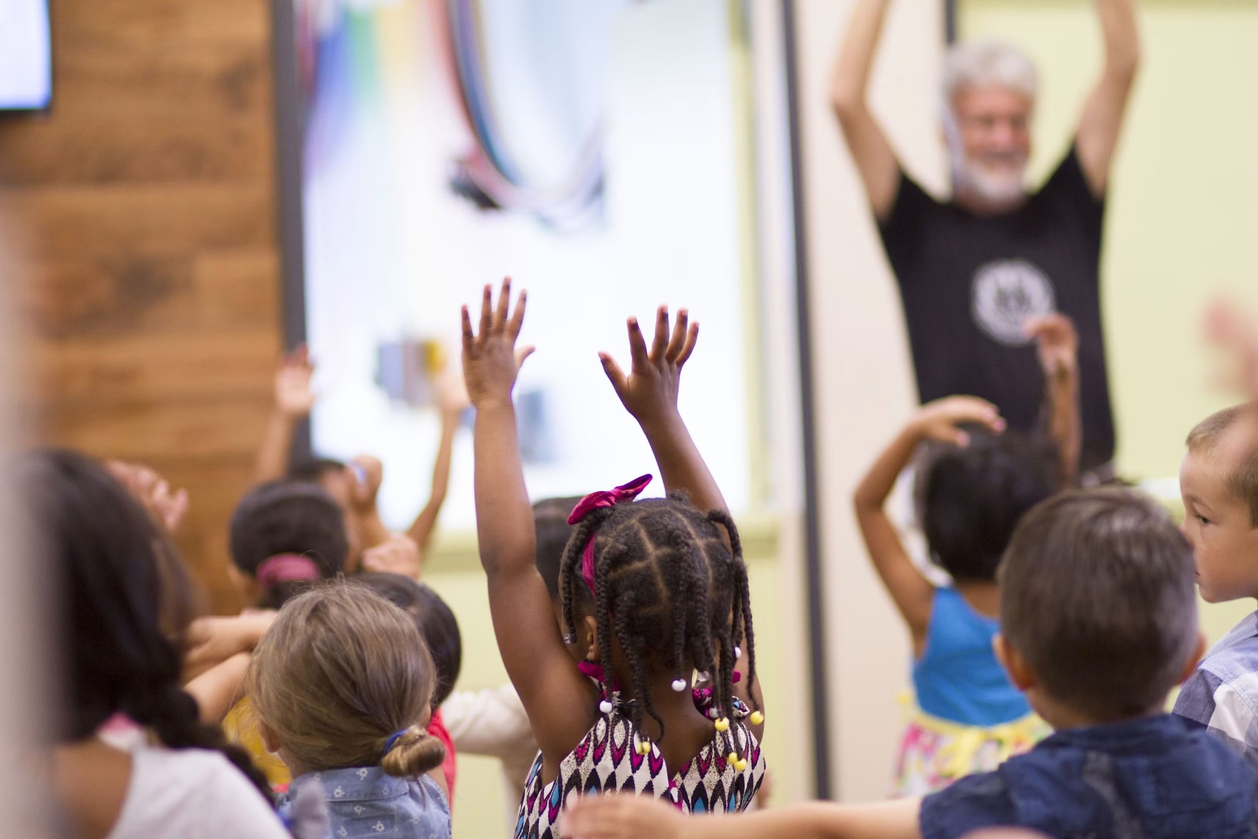 Children raising both hands