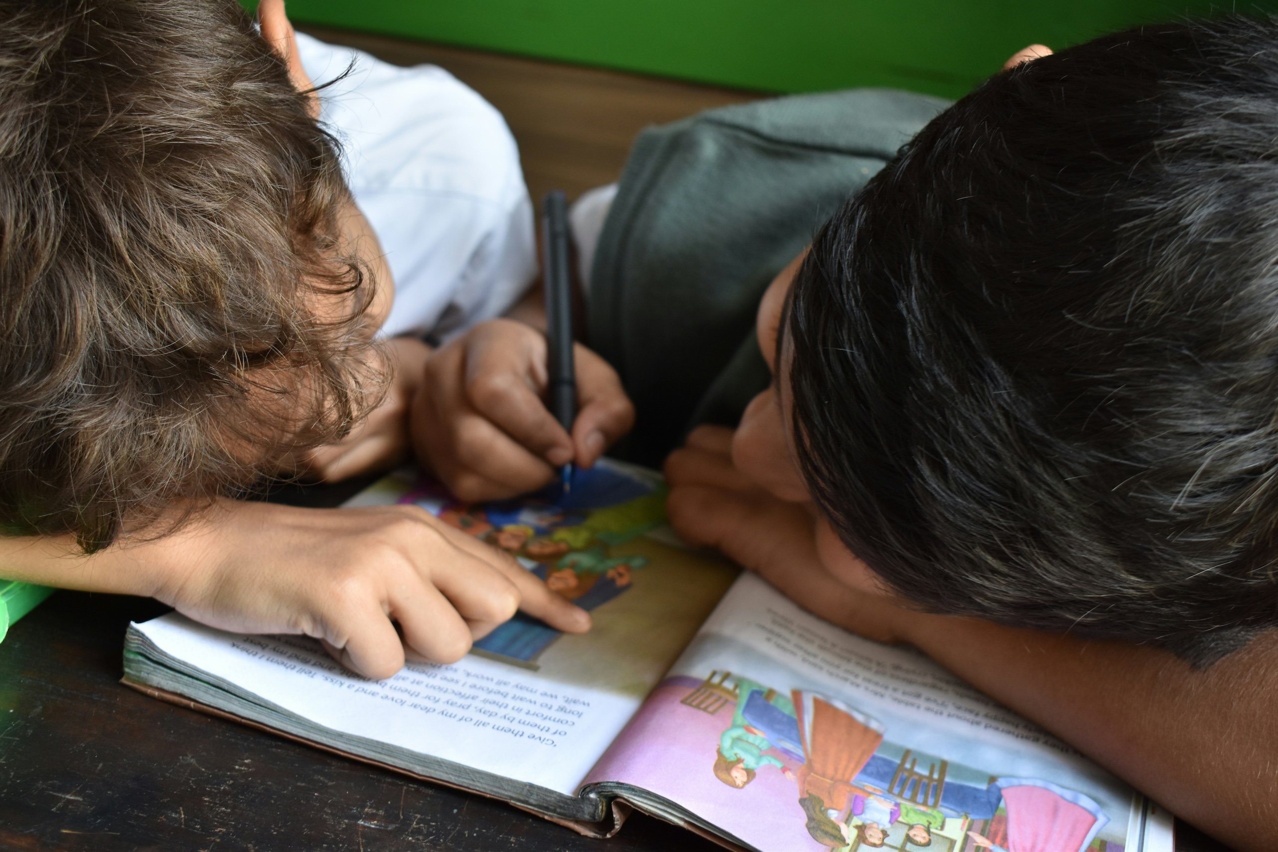 Two boys drawing together in the same colouring book | The Fort Learning Community